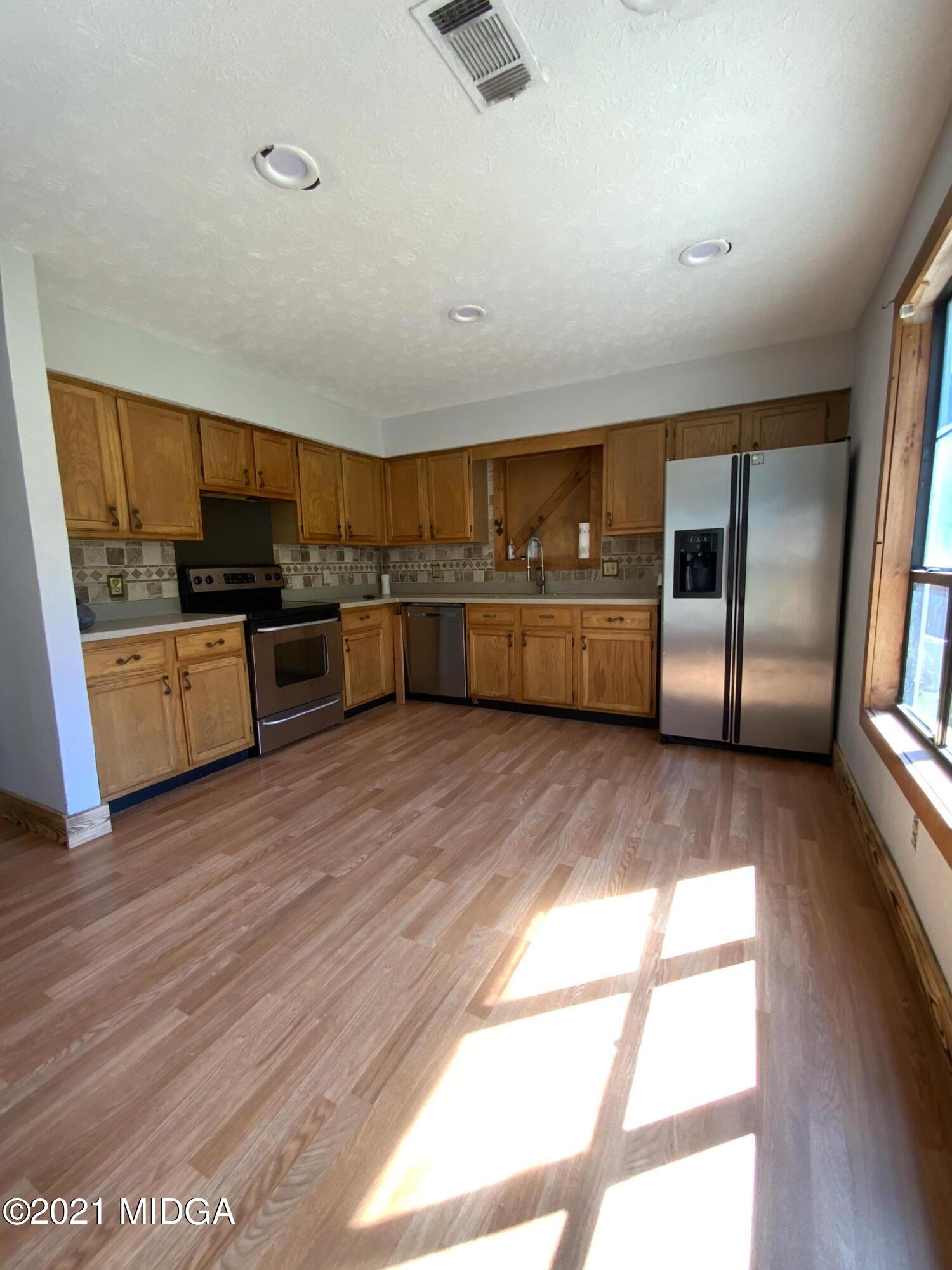 3482 Jordan Road Byron, GA 31008 - Photo 5 of 18 a kitchen with stainless steel appliances wooden floors and view living room