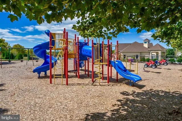 an aerial view of residential houses with outdoor space and car parked
