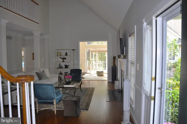 a living room with furniture fireplace and a large window
