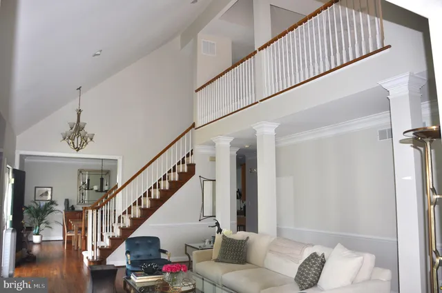 a living room with wooden floor and stairs
