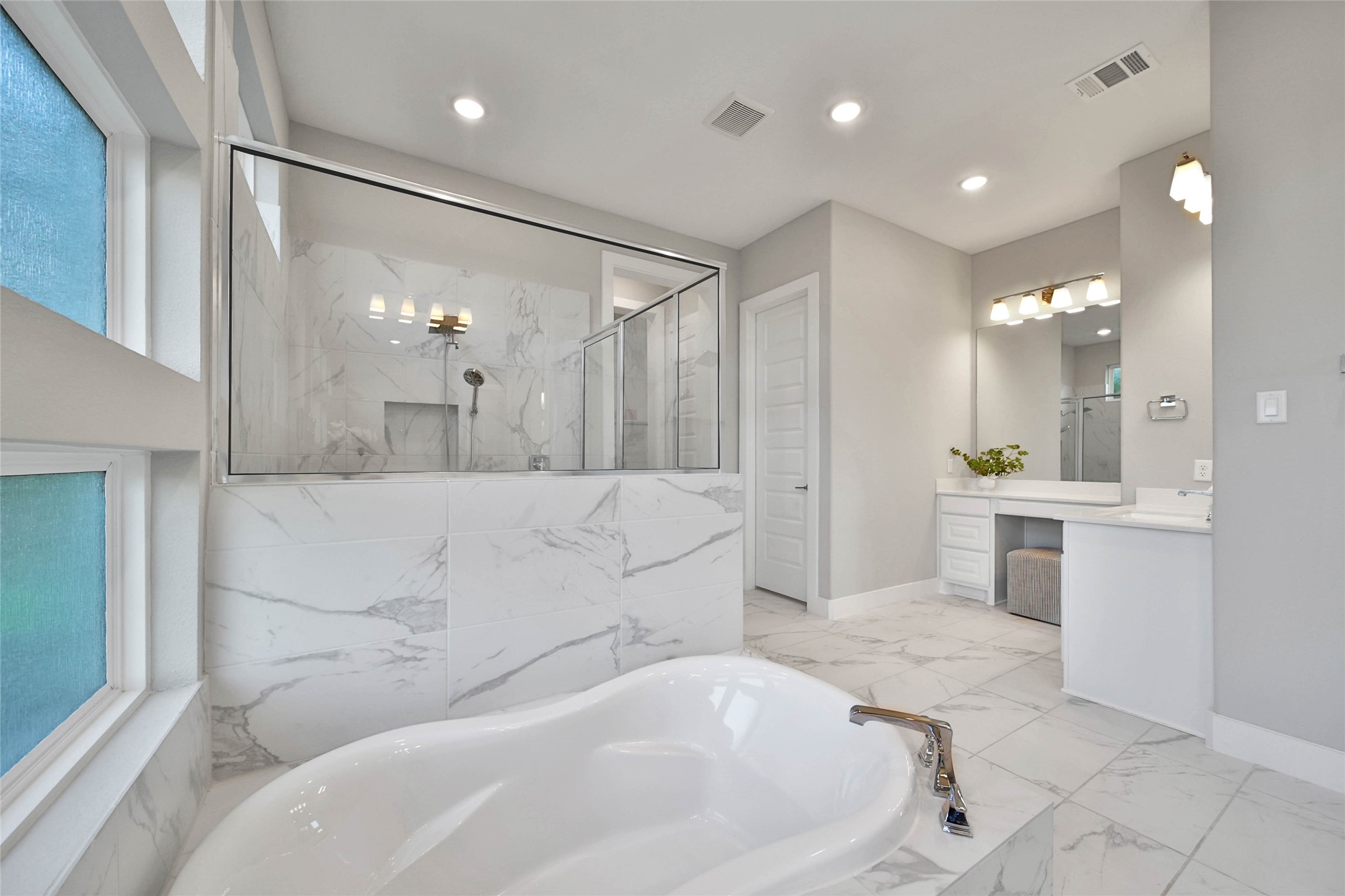 29402 Cir S Rnch Trail Fulshear, TX 77406 - Photo 27 of 50 Soak away any worries in the large soaking tub or the separate tiled shower, creating a true spa-like experience. This calming primary bath is designed for ultimate relaxation and comfort.