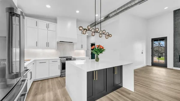 a kitchen with stainless steel appliances a sink stove and refrigerator