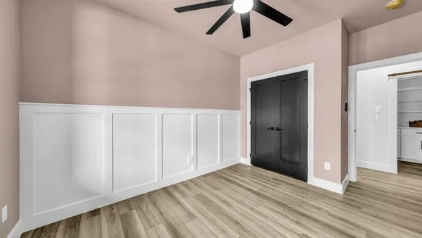 a view of an empty room with wooden floor