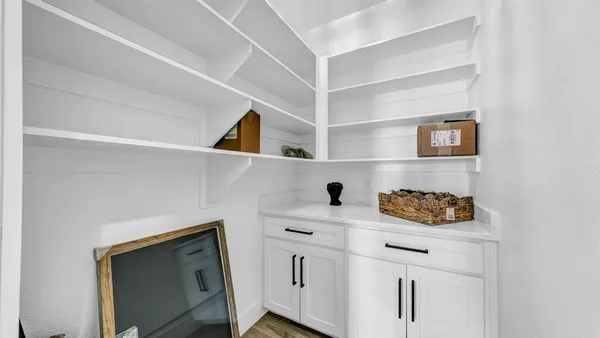 a utility room with a sink and cabinets
