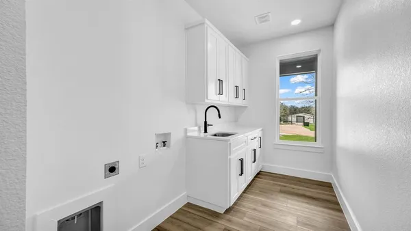 a spacious bathroom with a sink and a mirror