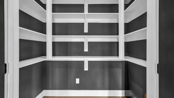 a view of an empty room with a cabinet