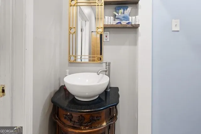 a bathroom with a sink and a mirror