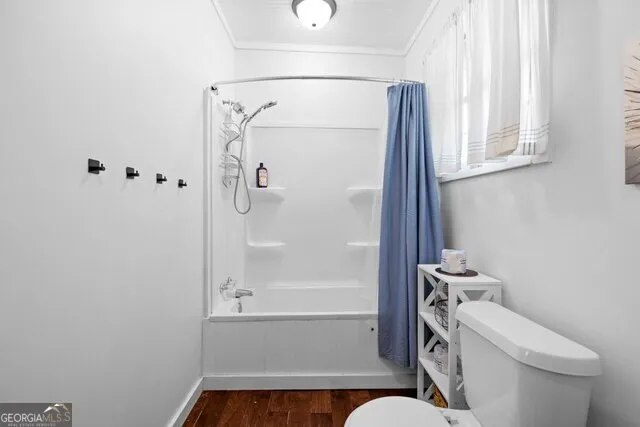 a bathroom with a toilet and a shower