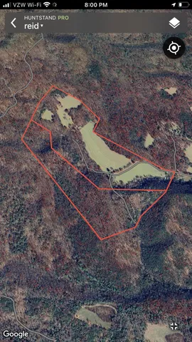 a view of a house with a yard and wooden fence
