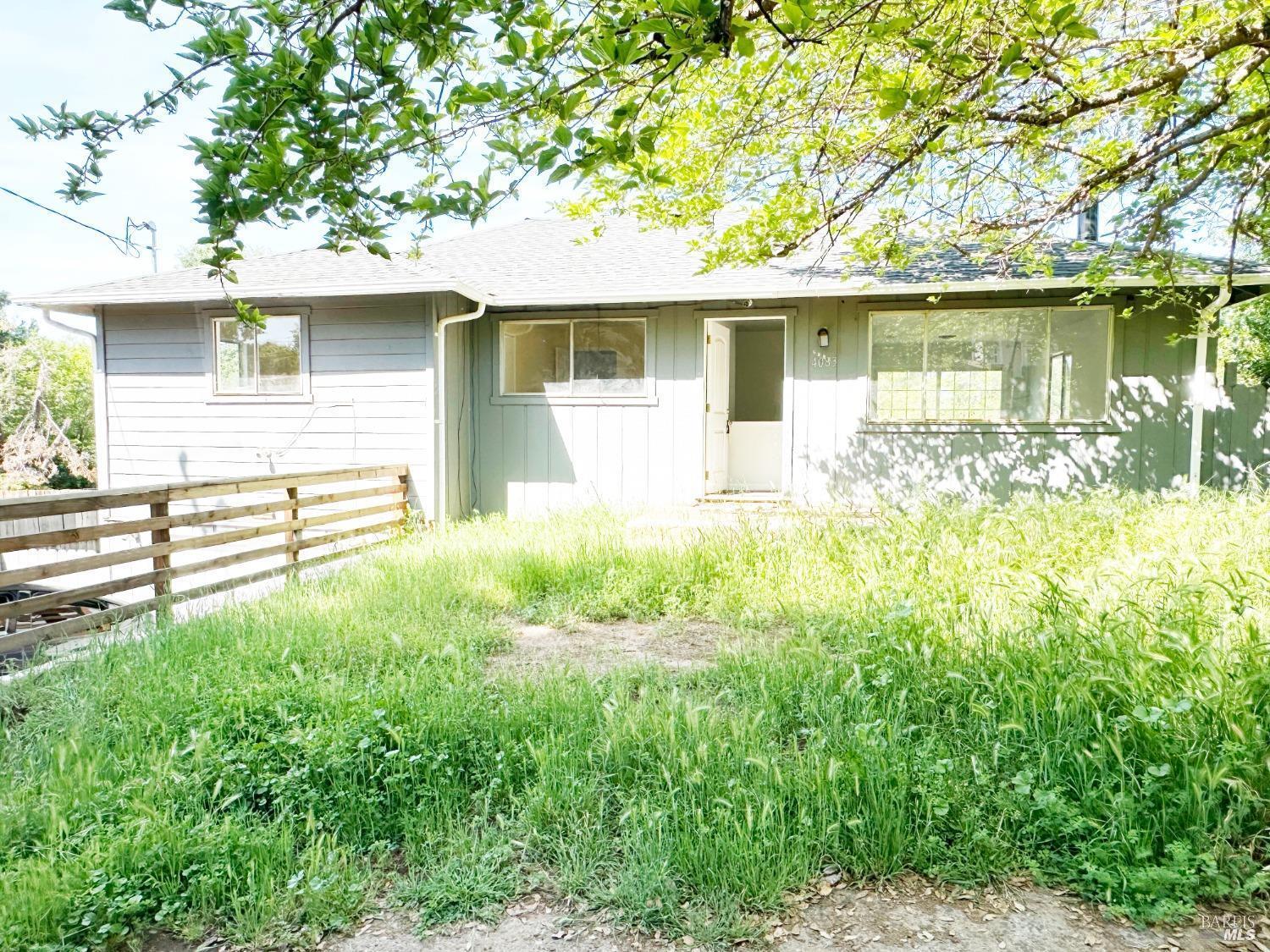 a front view of a house with a yard table and chairs