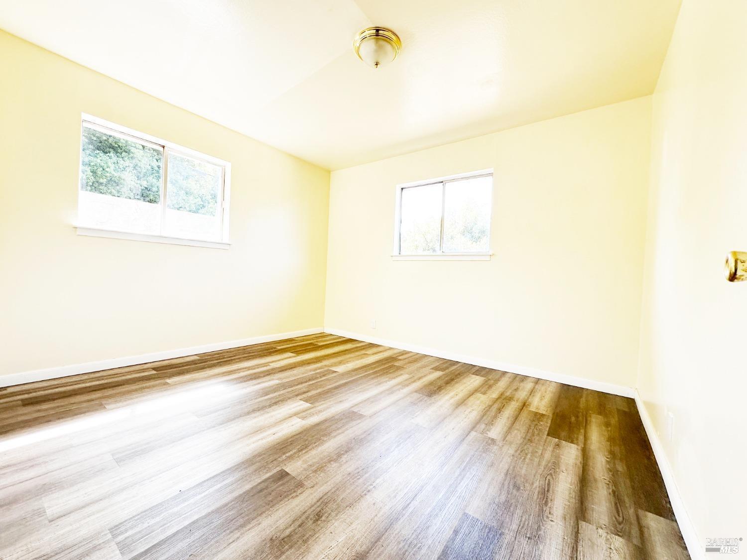 4083 Frye Avenue Clearlake, CA 95422 - Photo 7 of 18 a view of a room with wooden floor and a ceiling fan