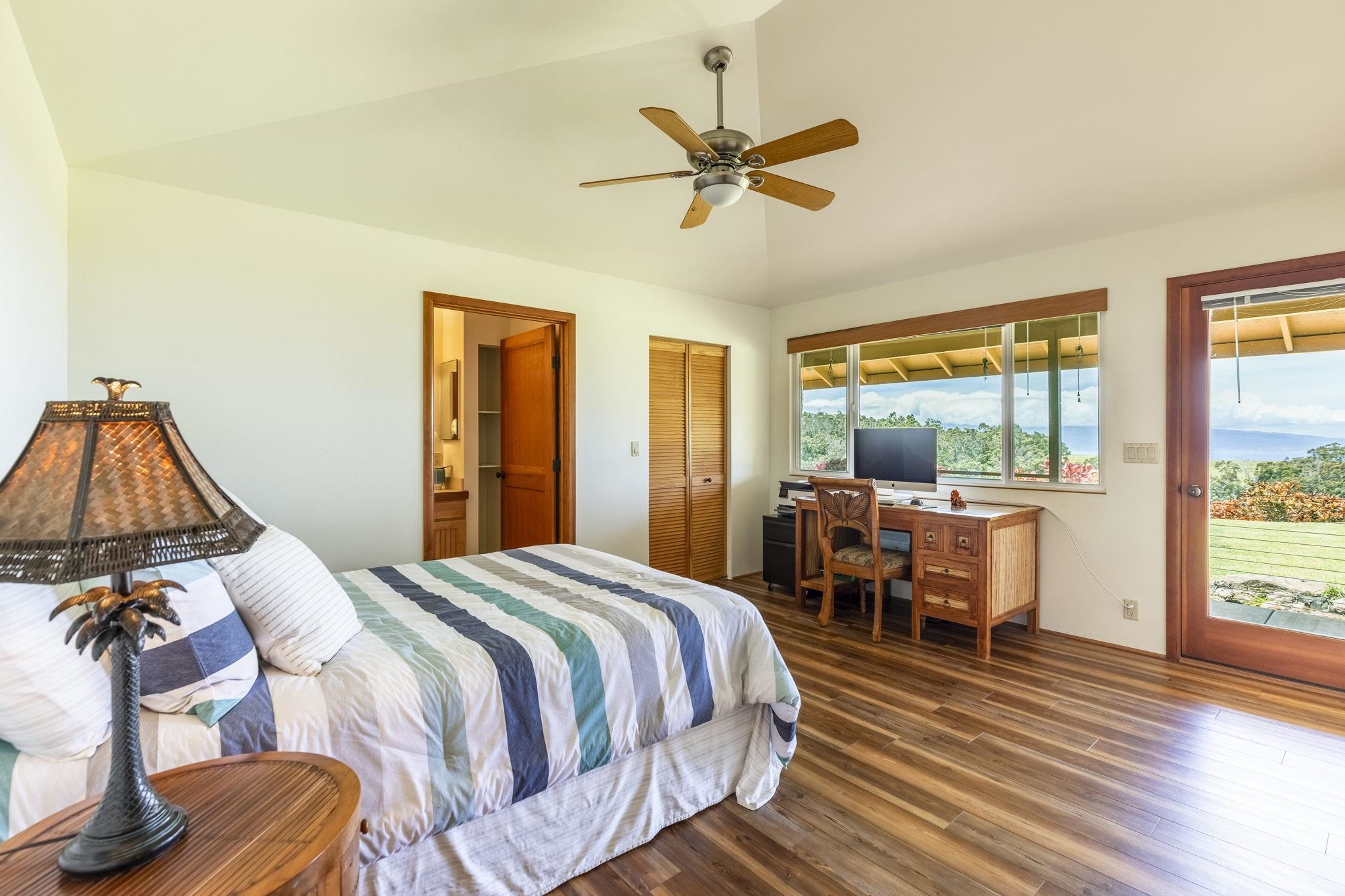 207 Uakoko Place Haiku, HI 96708 - Photo 22 of 30 a bedroom with a bed and wooden floor