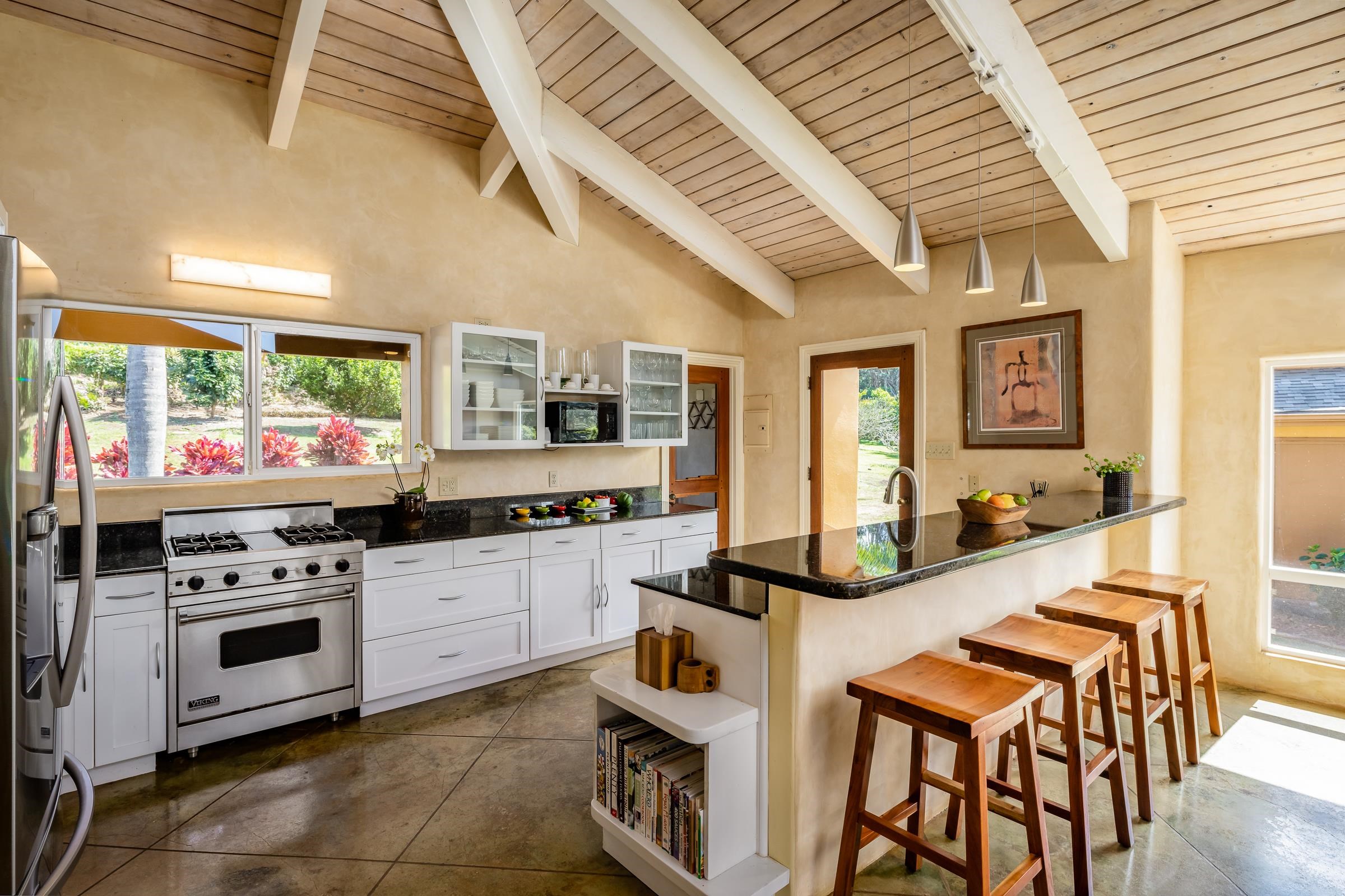 207 Uakoko Place Haiku, HI 96708 - Photo 5 of 30 a kitchen with stainless steel appliances granite countertop a stove and cabinets
