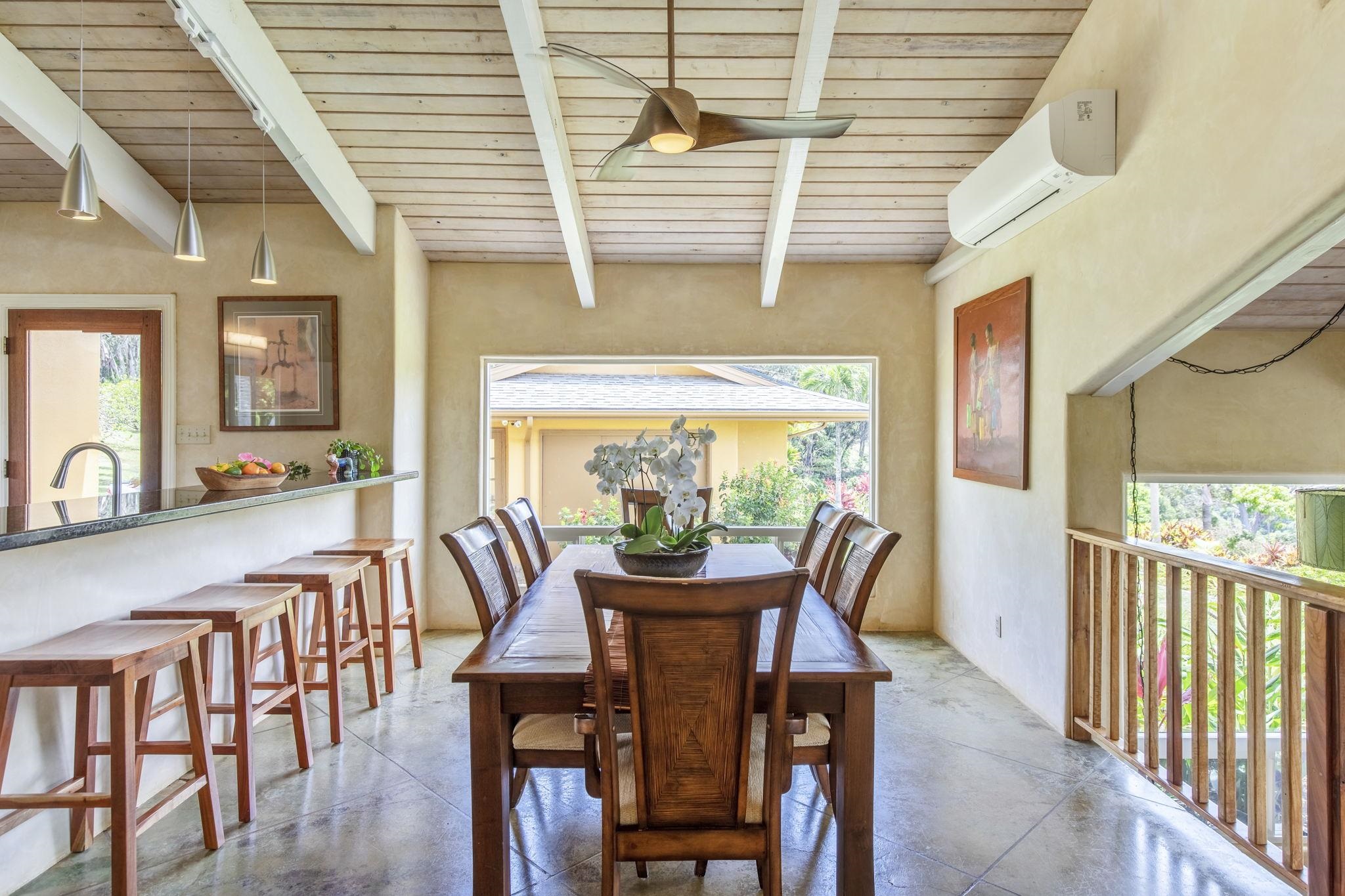 207 Uakoko Place Haiku, HI 96708 - Photo 6 of 30 a dining room with furniture a chandelier and wooden floor