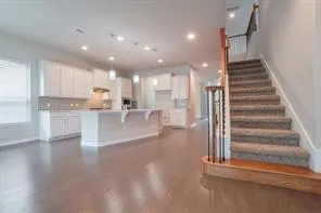 a view of kitchen with cabinets and wooden floor