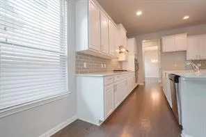 a kitchen with kitchen island white cabinets and white appliances