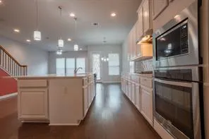 a view of a kitchen with a sink and microwave
