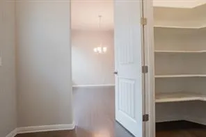 a view of walk in closet with empty racks