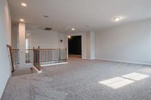 a view of a livingroom with stairs and an entryway