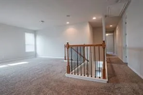 a view of staircase with white walls and windows