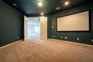 a view of an empty room with a projector and screen