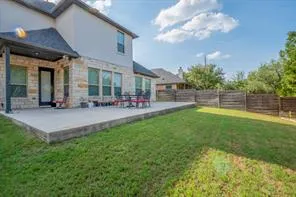 a view of a backyard with table and chairs and potted plants