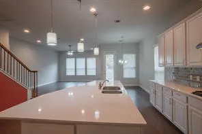 a view of a kitchen with a sink and cabinets