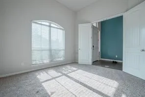 an empty room with large windows