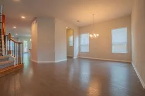 a view of a room with wooden floor and windows