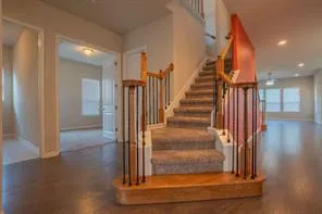 a view of entryway and hall with wooden floor