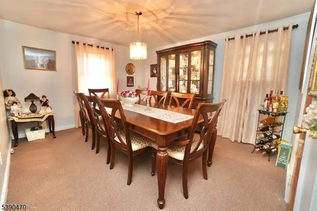 a view of a dining room with furniture and window