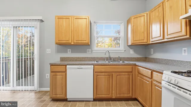 a kitchen with stainless steel appliances granite countertop a sink and a cabinets