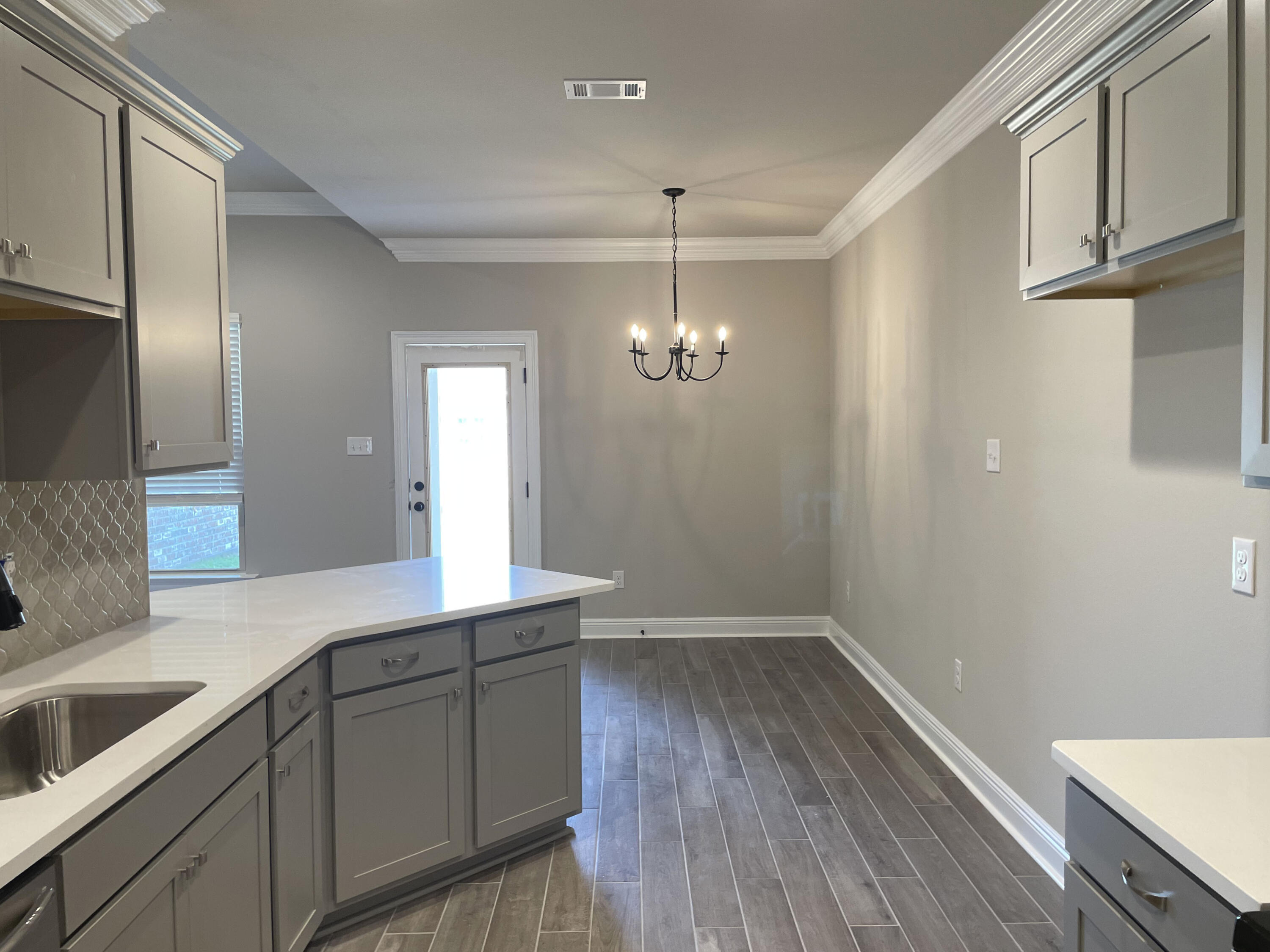 17 Alley Oak Lane Freeport, FL 32439 - Photo 2 of 6 a hallway with sink and wooden floor