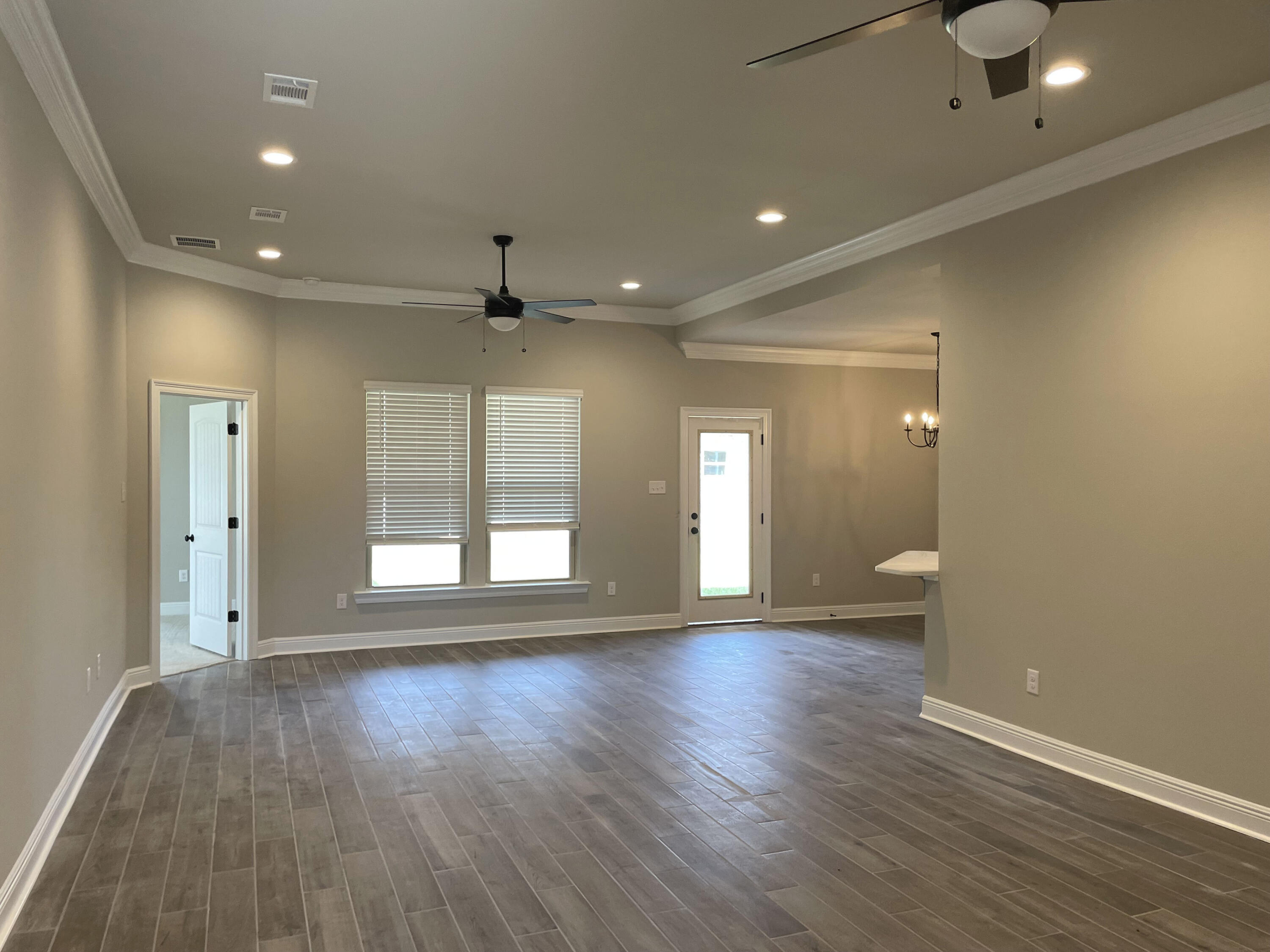17 Alley Oak Lane Freeport, FL 32439 - Photo 4 of 6 an empty room with wooden floor and windows