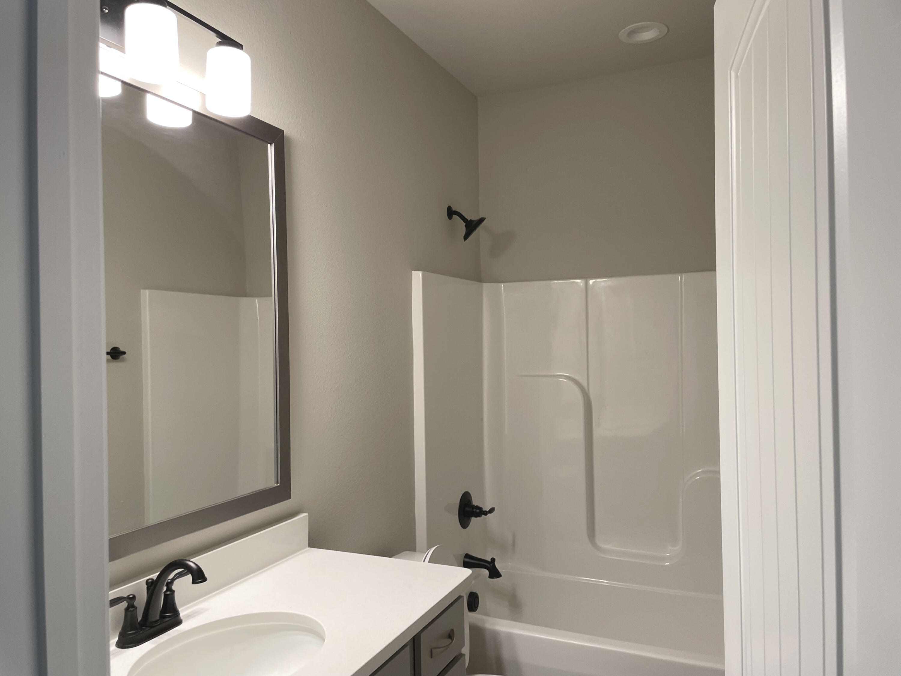 17 Alley Oak Lane Freeport, FL 32439 - Photo 5 of 6 a bathroom with a sink vanity mirror and shower