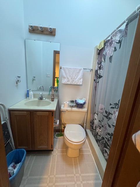 6100 Robbins Road Portage, IN 46368 - Photo 17 of 31 a bathroom with a sink a toilet and shower curtain