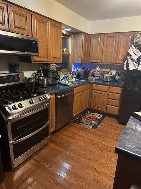 6100 Robbins Road Portage, IN 46368 - Photo 25 of 31 a kitchen with stainless steel appliances granite countertop a stove a sink dishwasher and cabinets with wooden floor