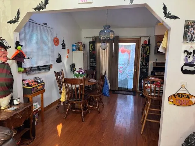 a view of a dining room with furniture and wooden floor