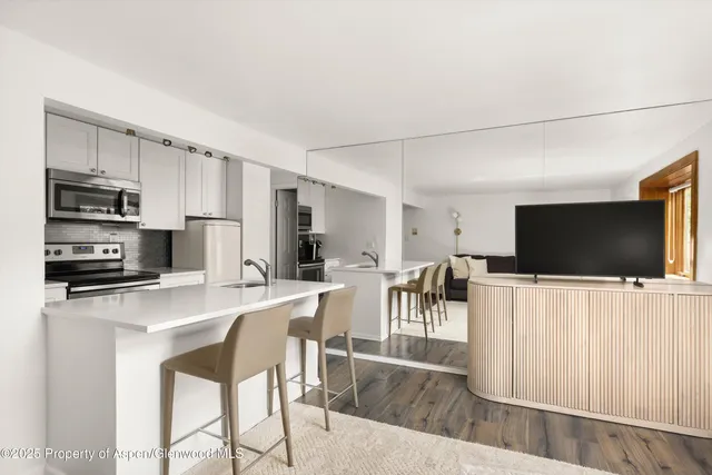a view of a dining room with furniture wooden floor and a flat screen tv