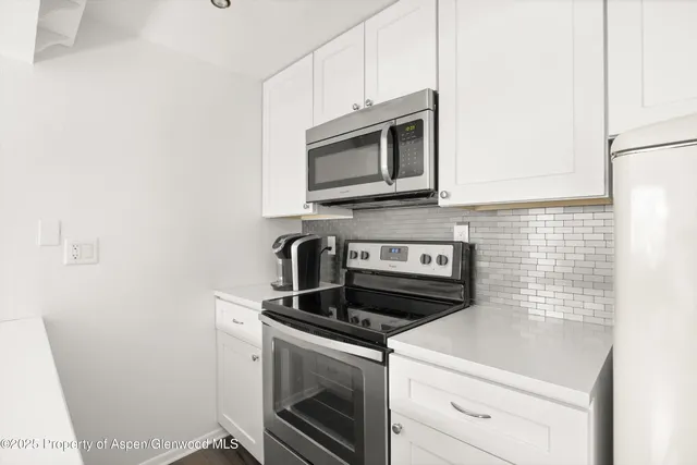 a kitchen with a stove and a microwave