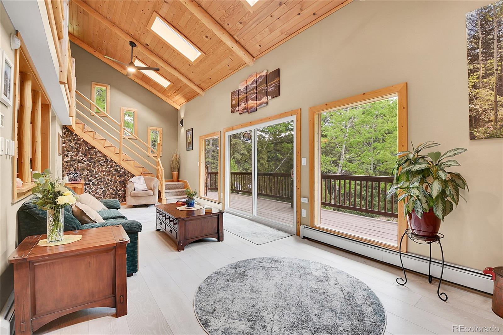 11182 Barney Gulch Road Conifer, CO 80433 - Photo 17 of 50 a living room with furniture and a floor to ceiling window