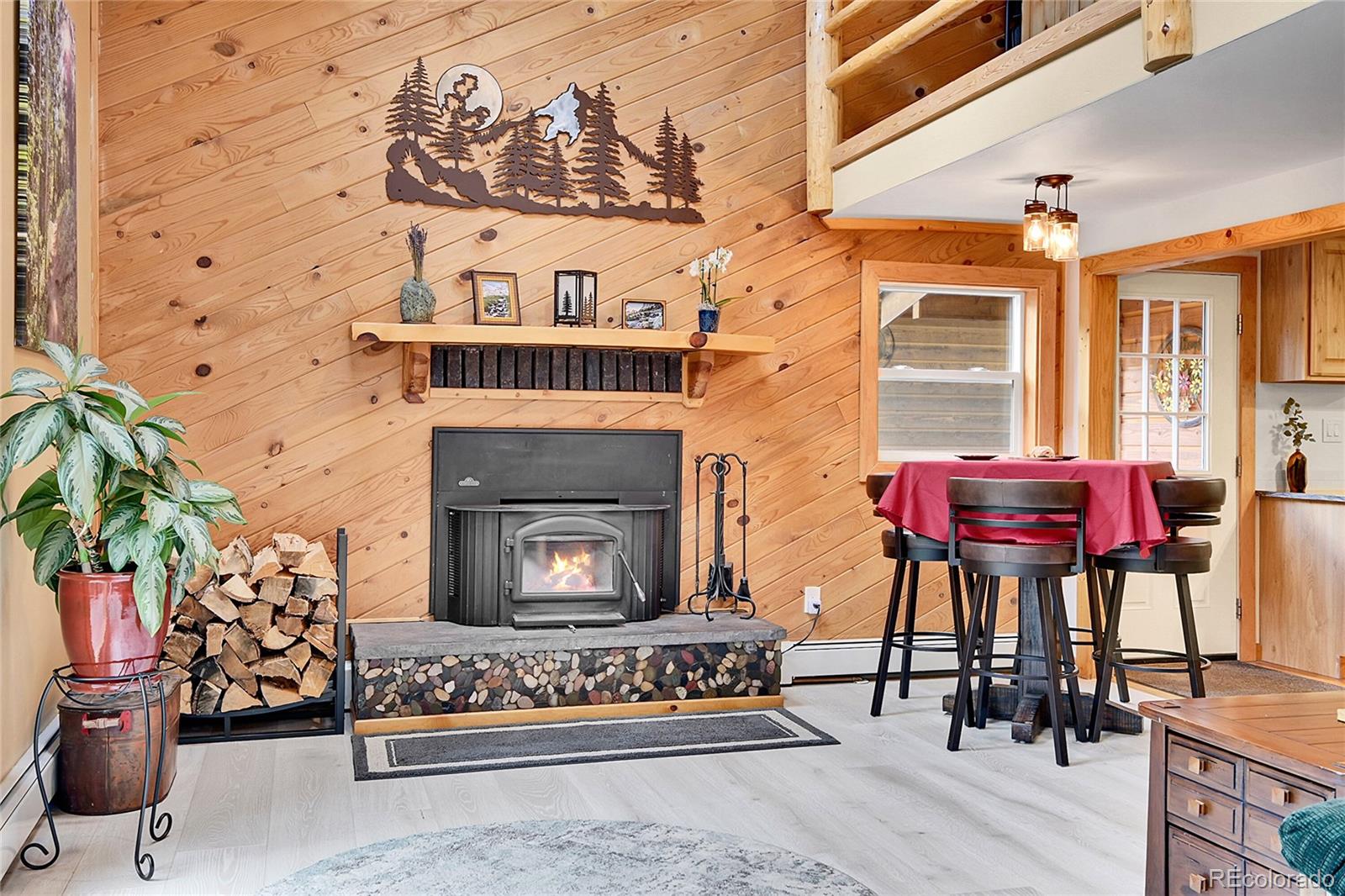 11182 Barney Gulch Road Conifer, CO 80433 - Photo 18 of 50 a living room with furniture and a fireplace