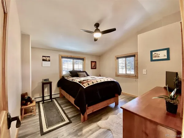 a bedroom with a bed and a desk