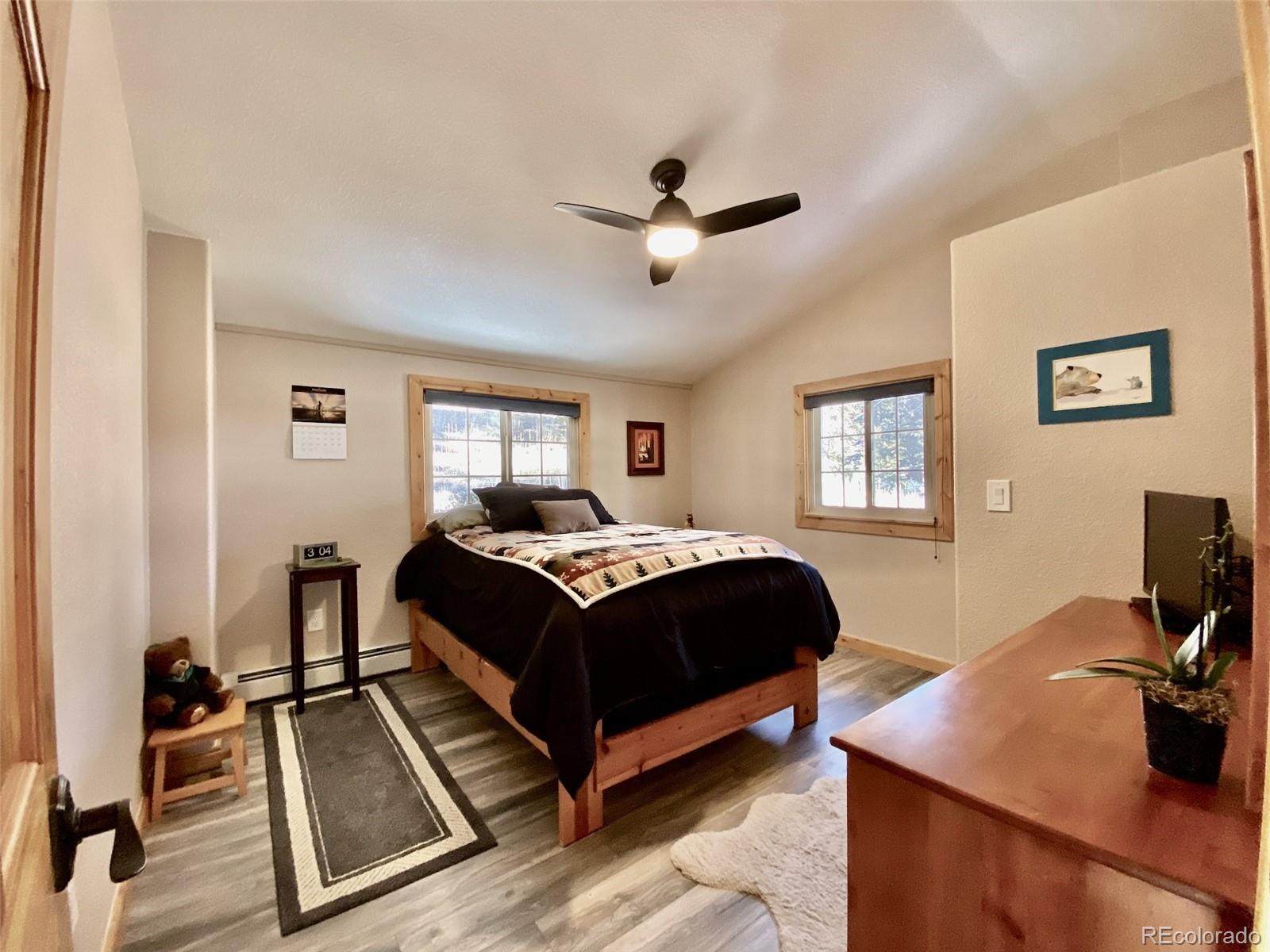 11182 Barney Gulch Road Conifer, CO 80433 - Photo 24 of 50 a bedroom with a bed and a desk