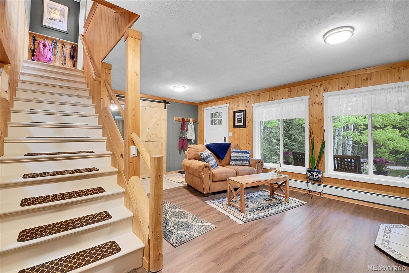 11182 Barney Gulch Road Conifer, CO 80433 - Photo 26 of 50 a living room with furniture and large windows