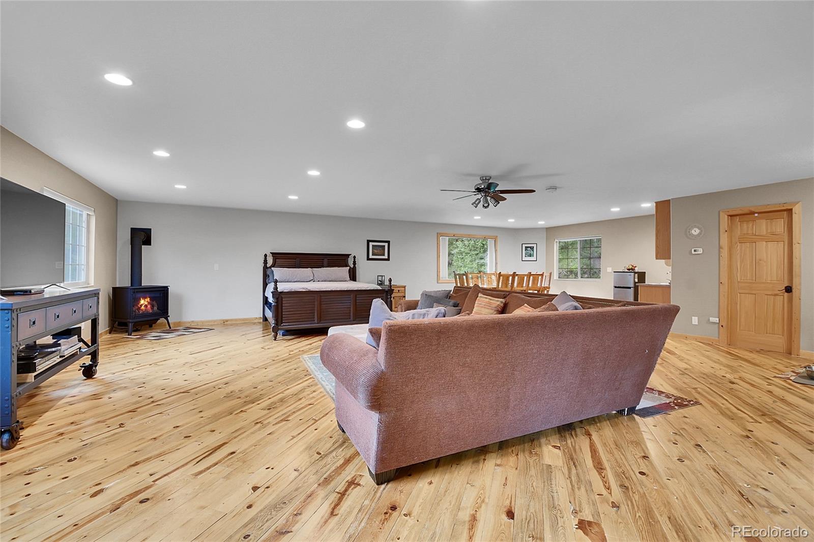 11182 Barney Gulch Road Conifer, CO 80433 - Photo 30 of 50 a living room with furniture and a wooden floor