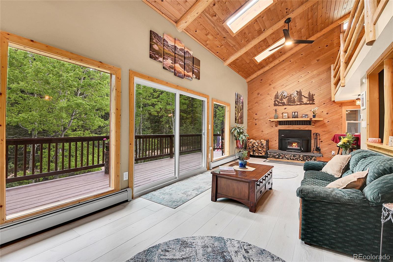 11182 Barney Gulch Road Conifer, CO 80433 - Photo 3 of 50 a living room with furniture fireplace and flat screen tv