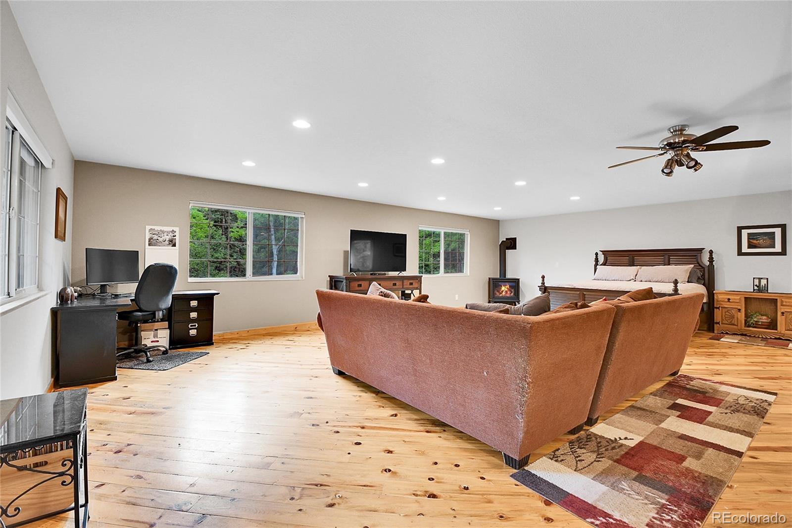 11182 Barney Gulch Road Conifer, CO 80433 - Photo 31 of 50 a living room with furniture and a flat screen tv