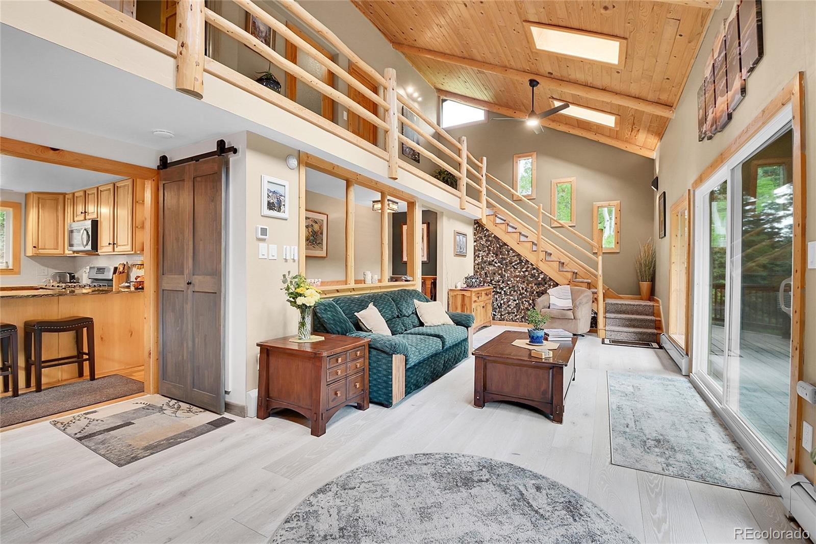11182 Barney Gulch Road Conifer, CO 80433 - Photo 4 of 50 a living room with furniture and a view of kitchen