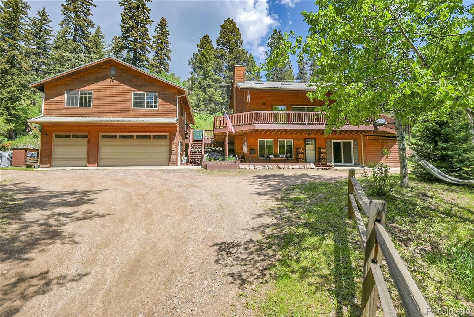 11182 Barney Gulch Road Conifer, CO 80433 - Photo 42 of 50 front view of a house with a yard